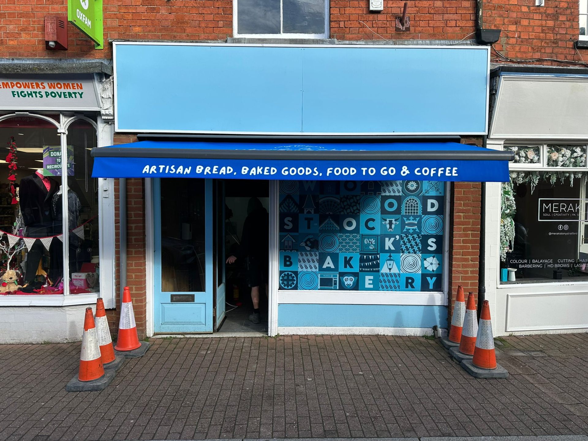Aura Plus awning with custom-branded blue valance at Woodstock's Bakery, Stony Stratford