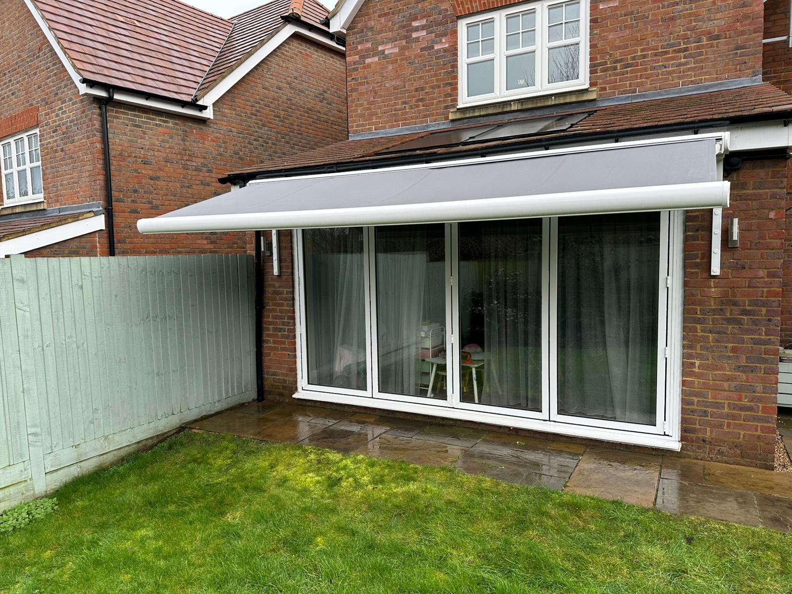 Motorised Aura Plus extended over bifold doors and patio at Tring home