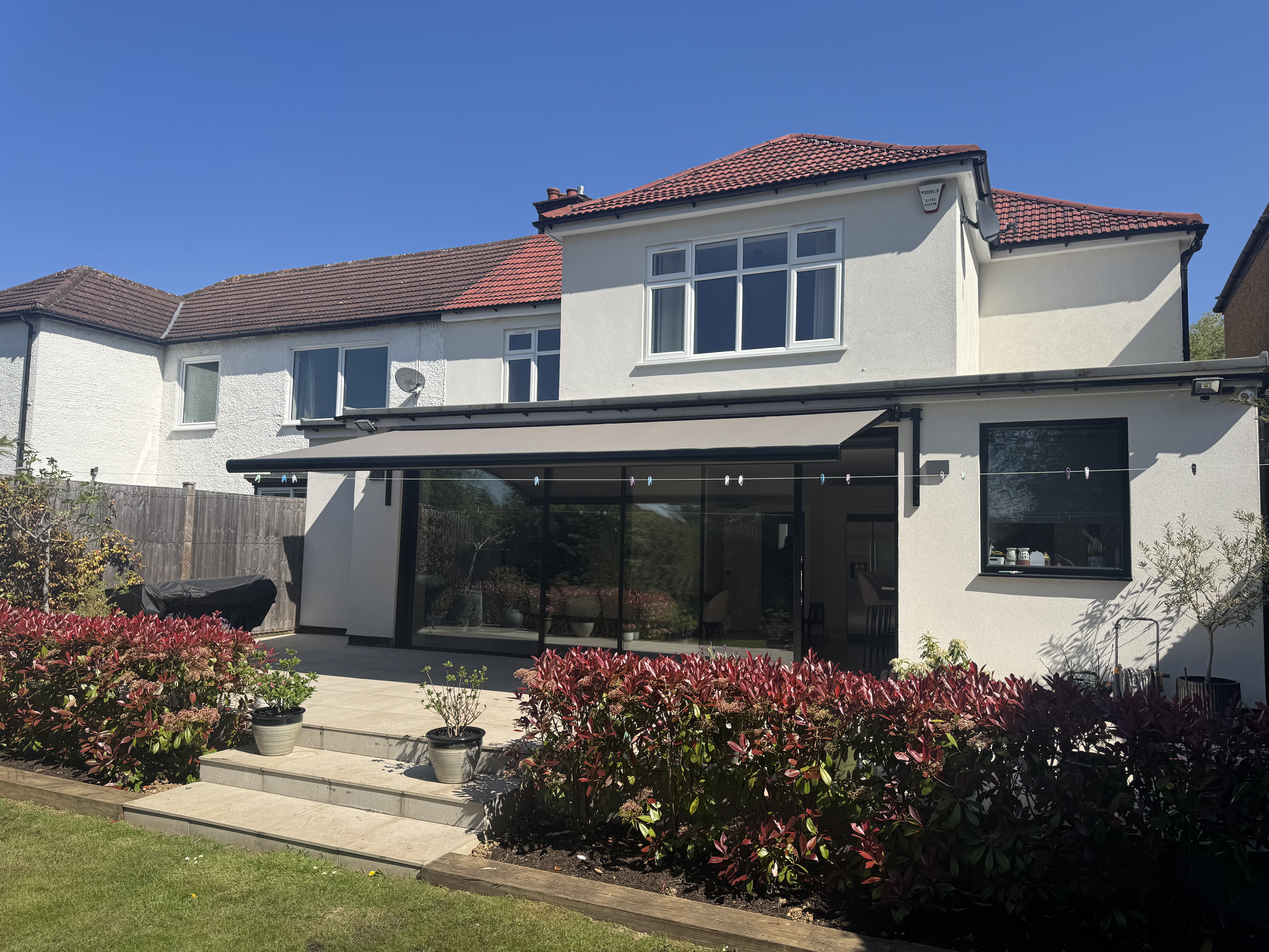 Aura Plus extended above bifold doors, rear garden view, Stanmore