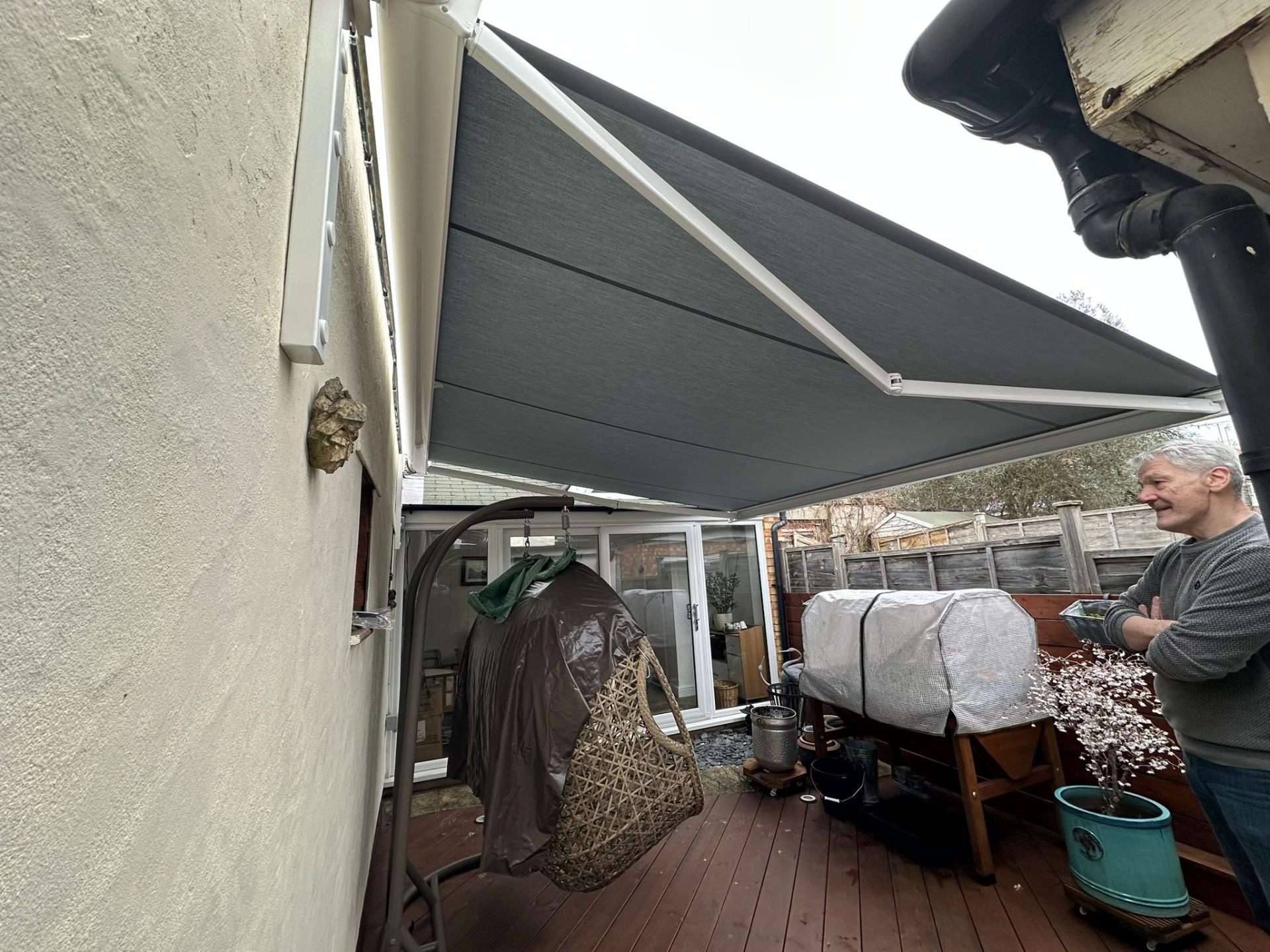 Charcoal Aura Plus awning extended over decked patio at Reading home