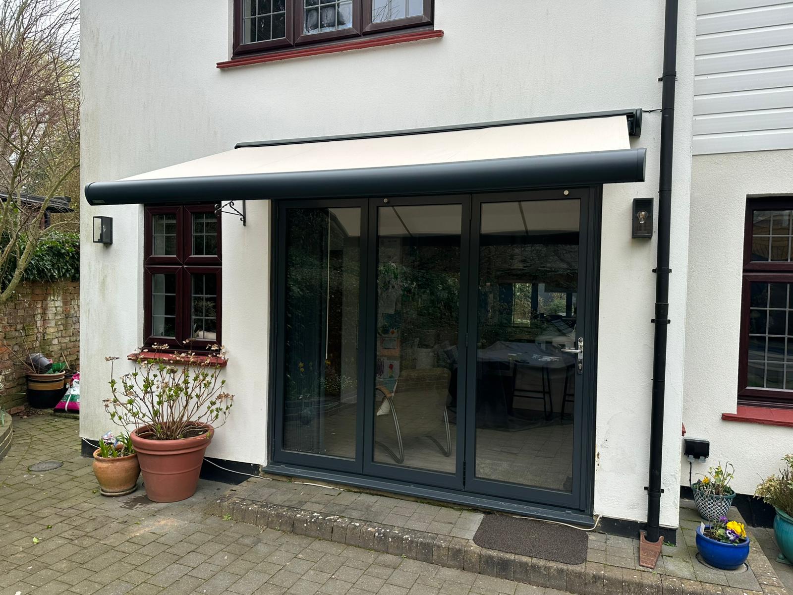 Anthracite Aura Plus extended over bifold doors at Radlett home
