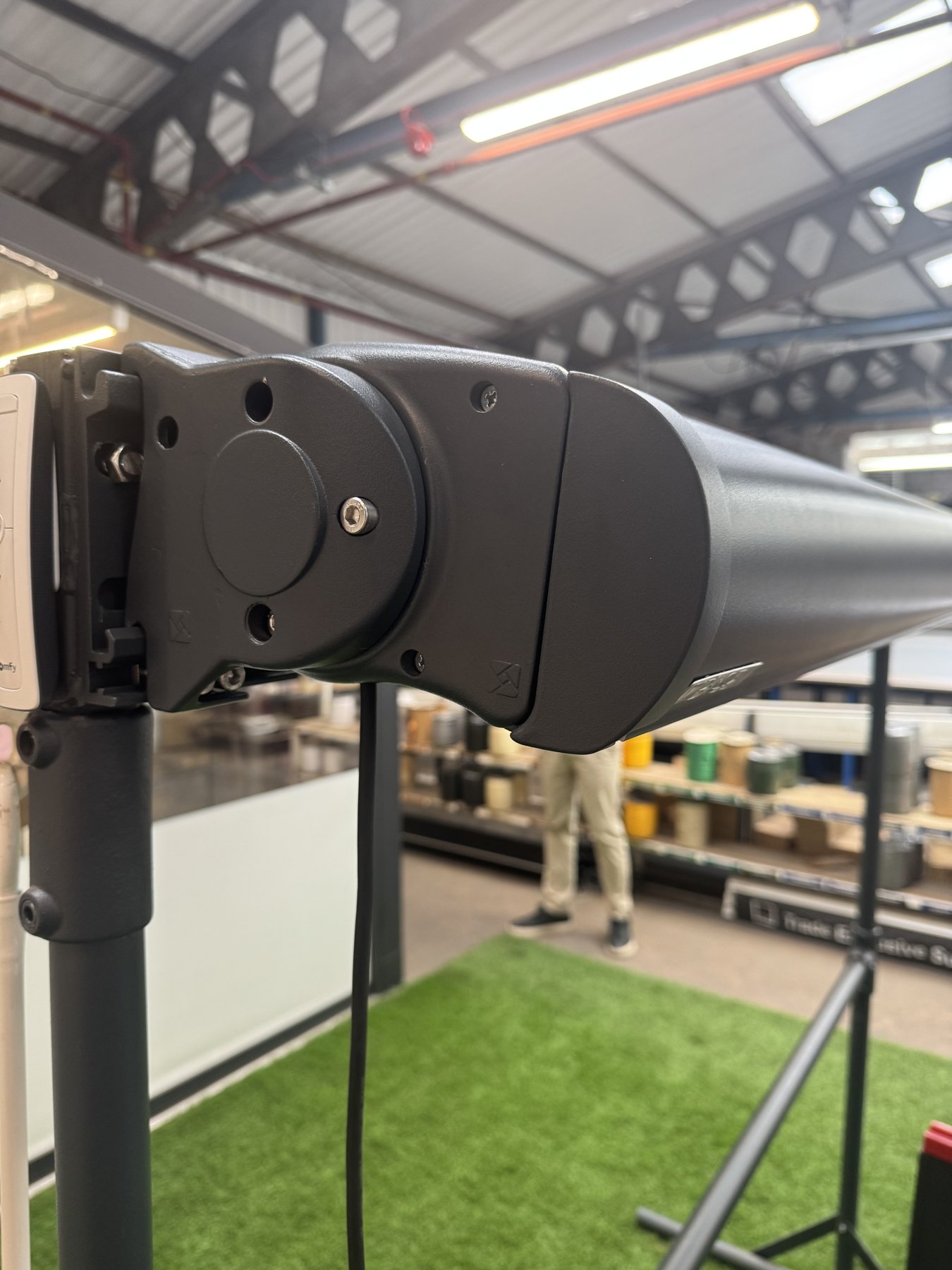 Close-up of a folding-arm awning mechanism on the factory bench