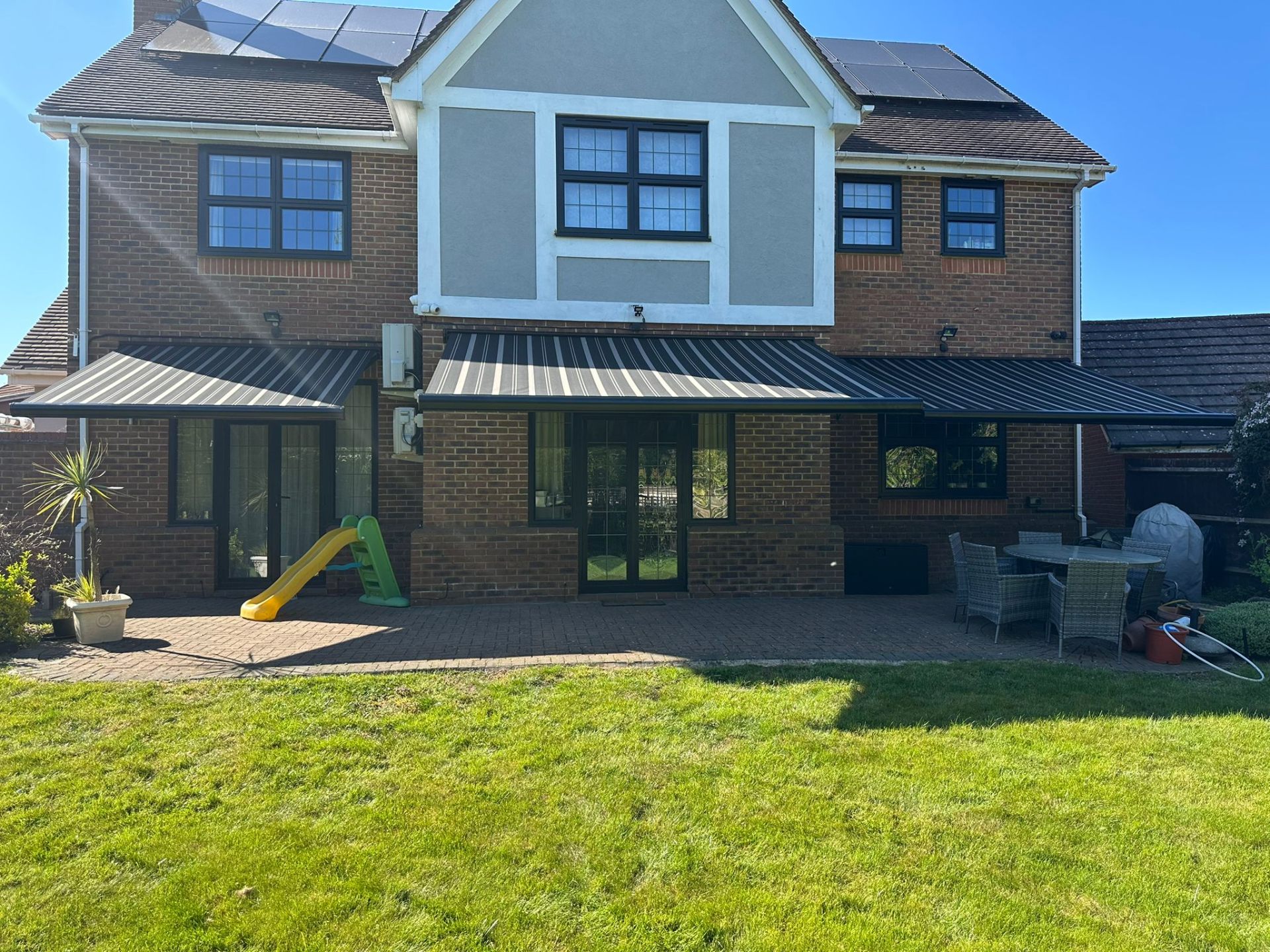Three Aura Plus awnings extended across rear elevation, Stanmore