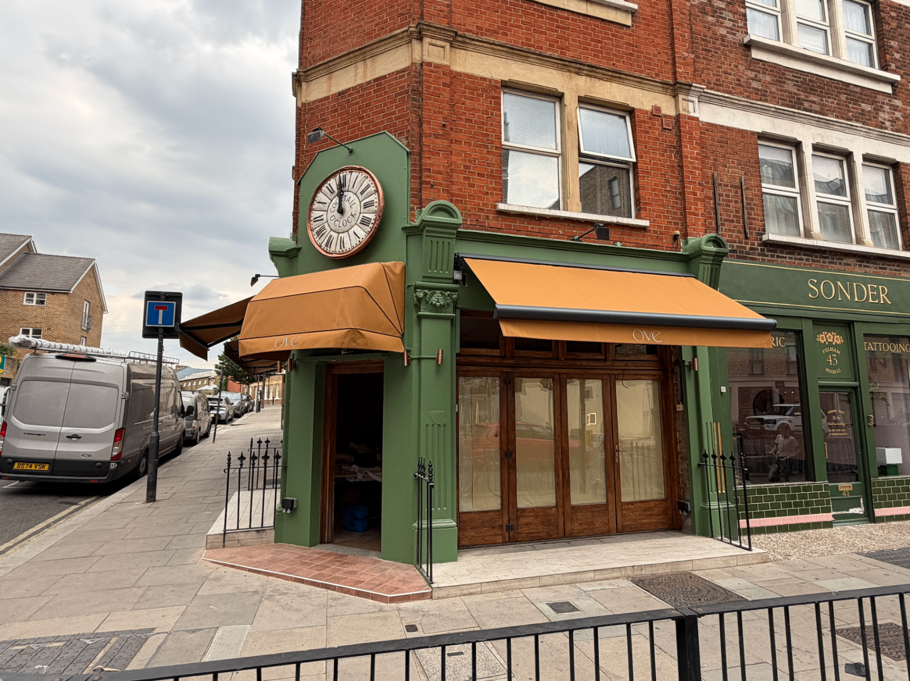 Aura Plus in anthracite over the entrance of Ove restaurant on Fulham High Street with branded valance